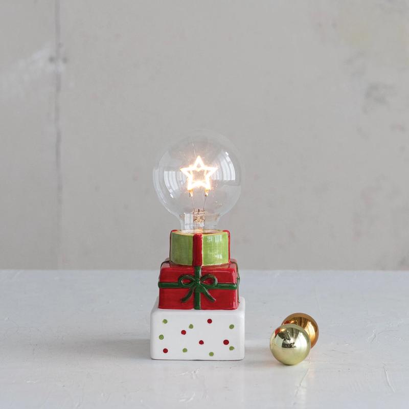 LED Star Shaped Filament Lightbulb  on Top of Holiday Packages