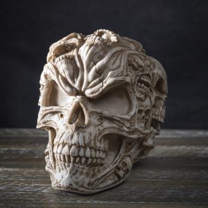 Gothic Morphing Evil Skull with Ghost Spirit Skulls On Its Surface Figurine