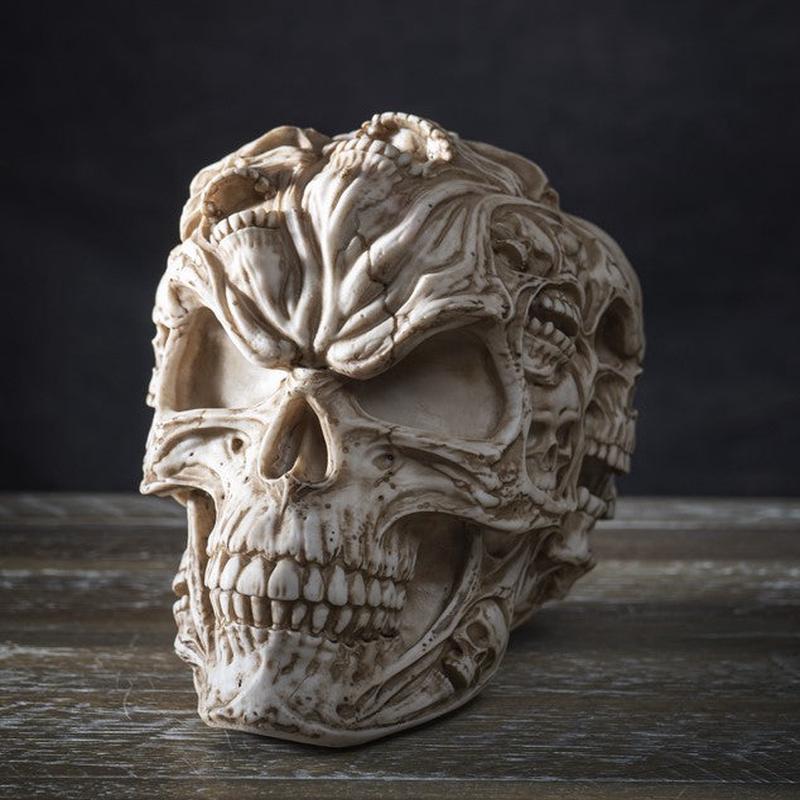 Gothic Morphing Evil Skull with Ghost Spirit Skulls On Its Surface Figurine