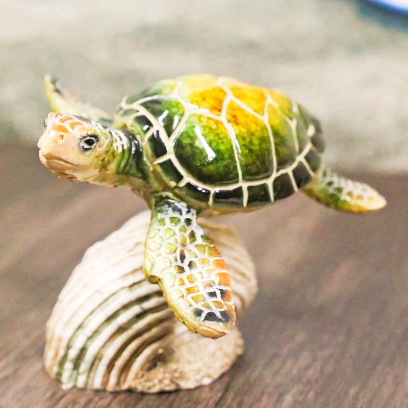 Marine Green Sea Turtle Swimming Over Partridge Tun Shell Spring Bobble Figurine